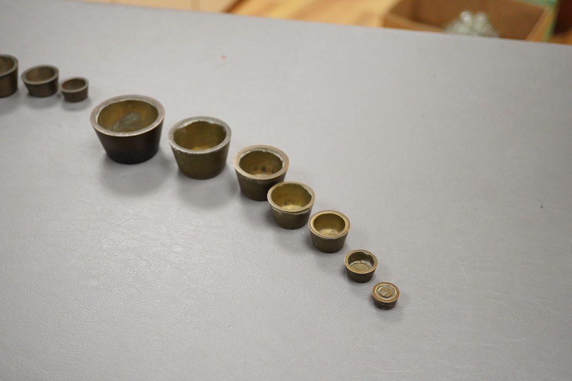 Two sets of bronze Troy nesting weights, one incomplete, with engraved rims, largest 8oz